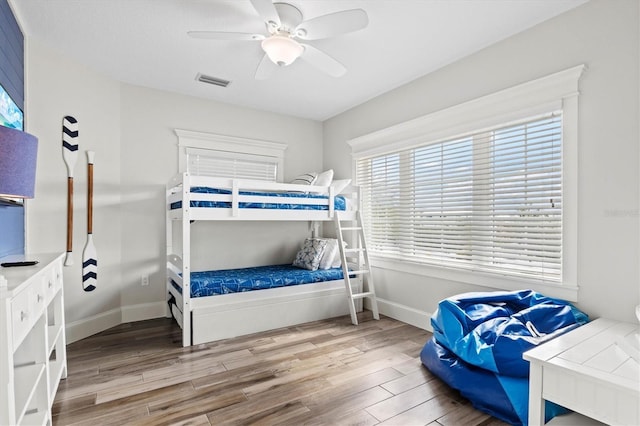 bedroom with hardwood / wood-style floors and ceiling fan