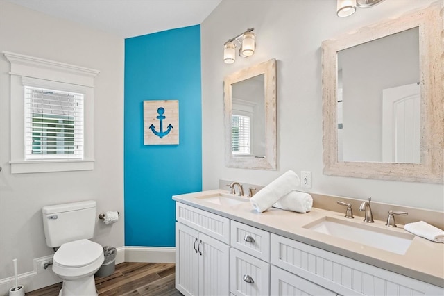 bathroom with hardwood / wood-style floors, vanity, and toilet