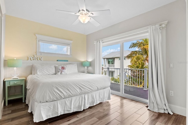 bedroom with multiple windows, wood-type flooring, access to outside, and ceiling fan