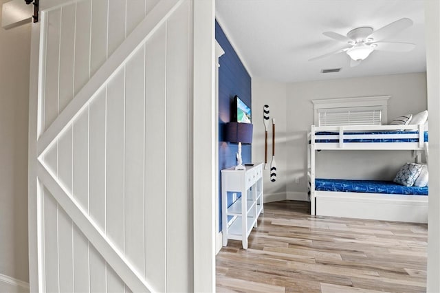 bedroom with hardwood / wood-style floors and ceiling fan