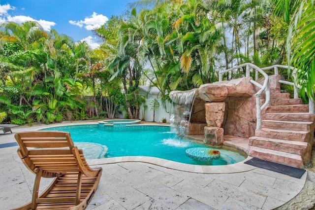 view of pool featuring an in ground hot tub