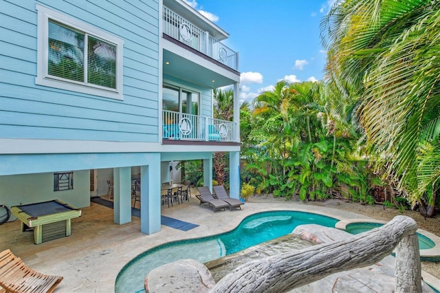 view of pool featuring a patio area and an in ground hot tub