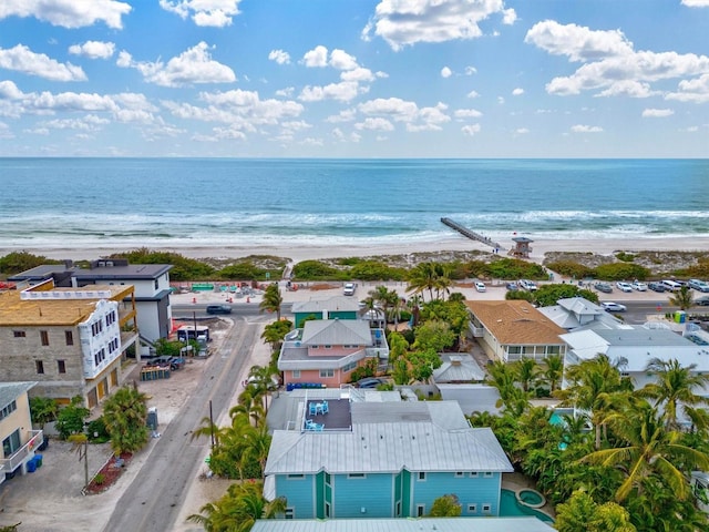 birds eye view of property featuring a water view and a beach view