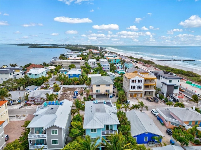 aerial view with a water view and a beach view