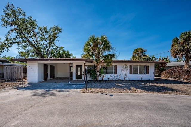 ranch-style house featuring a carport