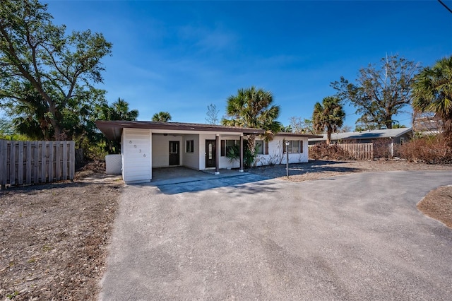 ranch-style house featuring a carport