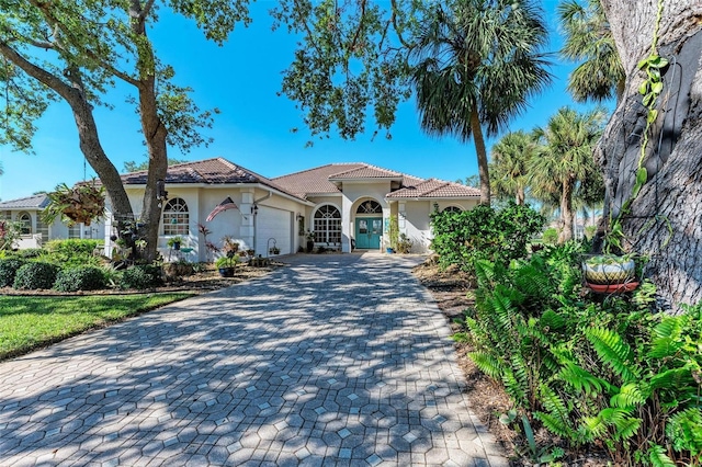 mediterranean / spanish-style home featuring a garage