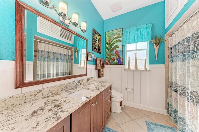 bathroom with tile patterned flooring, vanity, curtained shower, and toilet