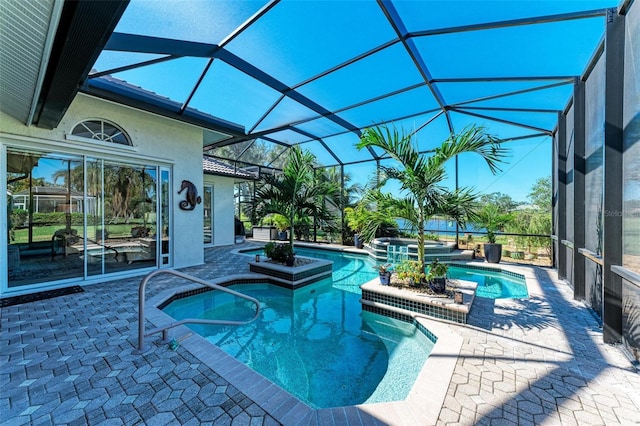 view of swimming pool with glass enclosure, a patio area, and an in ground hot tub