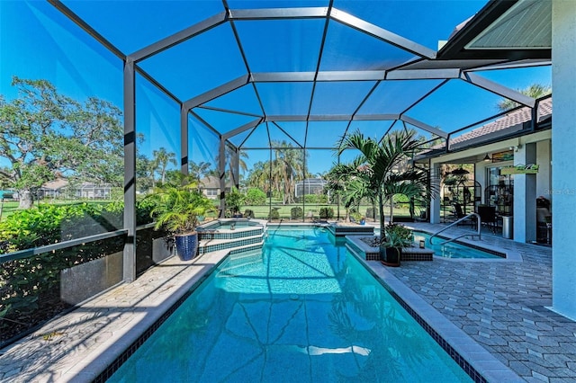 view of pool featuring a lanai, an in ground hot tub, ceiling fan, and a patio