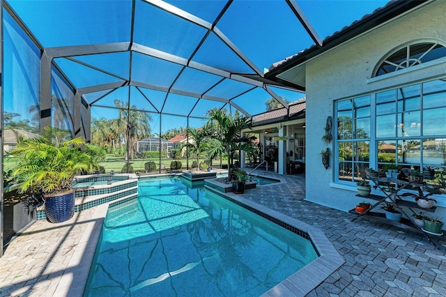 view of swimming pool with a lanai, an in ground hot tub, and a patio