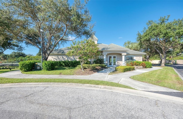 view of front of home featuring french doors and a front yard