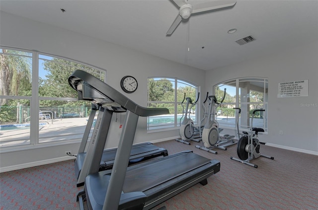 exercise room with carpet and ceiling fan