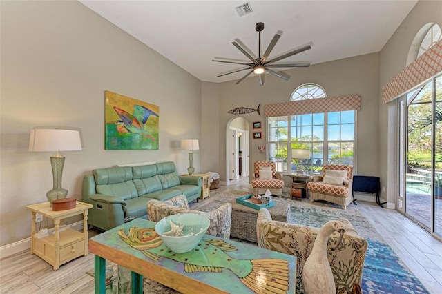 living room with ceiling fan and light wood-type flooring