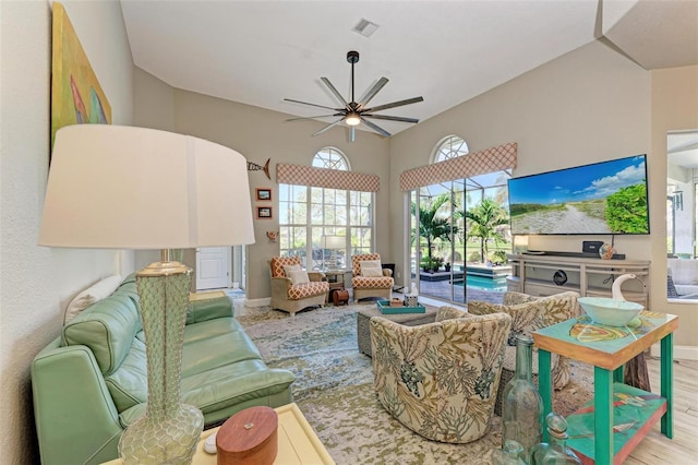 living room featuring ceiling fan and light hardwood / wood-style floors