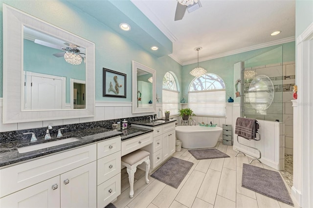 bathroom featuring vanity, ceiling fan, crown molding, and plus walk in shower