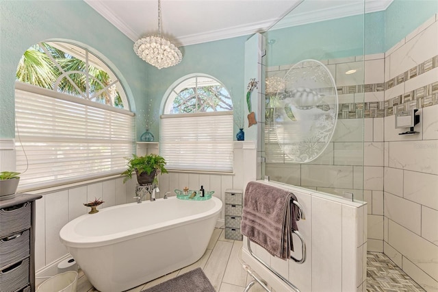 bathroom with separate shower and tub, ornamental molding, and an inviting chandelier