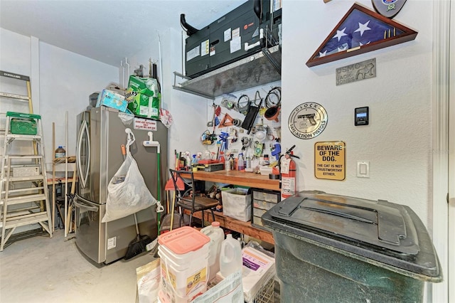 miscellaneous room featuring a workshop area and concrete floors