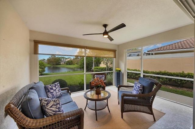 sunroom with a water view and ceiling fan