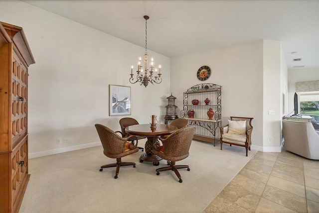 dining space with light colored carpet and a chandelier