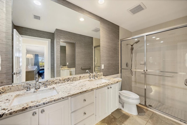 bathroom featuring vanity, toilet, and walk in shower