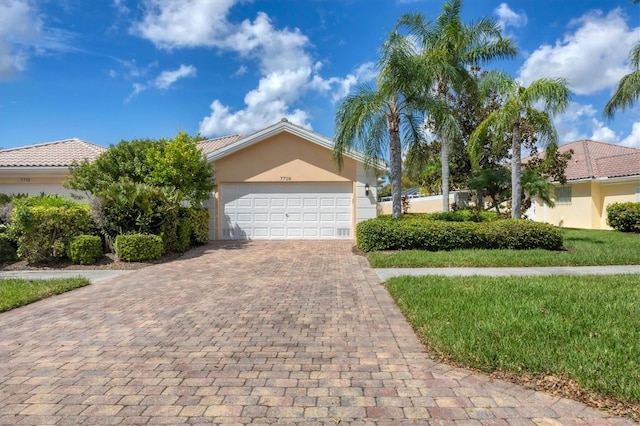 view of front facade with a garage and a front lawn