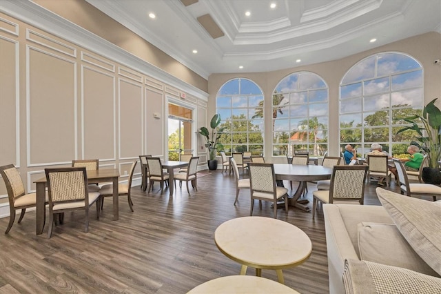 interior space featuring dark hardwood / wood-style flooring, ornamental molding, and a towering ceiling