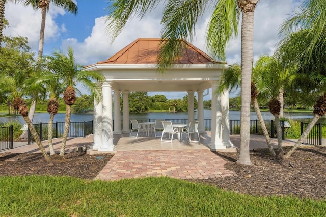 view of patio with a gazebo and a water view