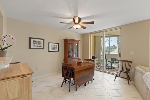 office area featuring ceiling fan, light tile patterned floors, and a textured ceiling