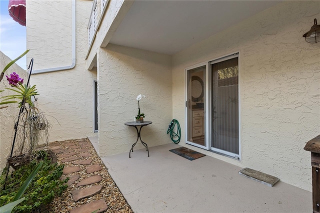 entrance to property with a patio