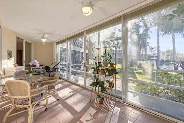 sunroom / solarium featuring ceiling fan