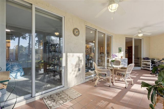 sunroom featuring ceiling fan