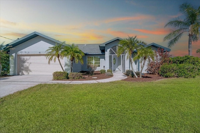 ranch-style home with a lawn and a garage