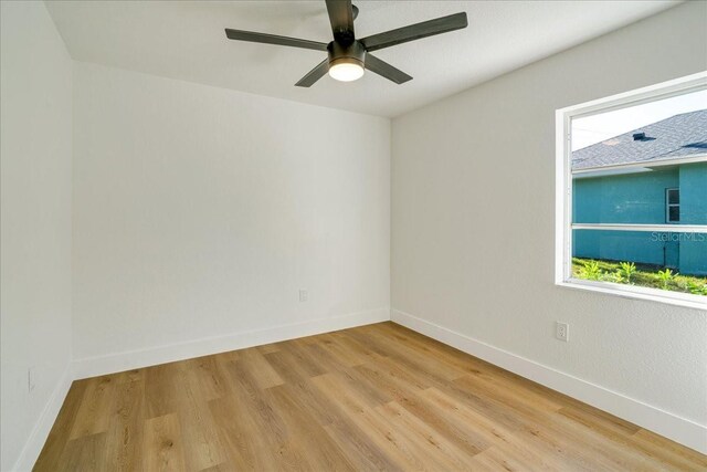 spare room featuring a healthy amount of sunlight and light wood-type flooring