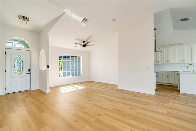 entryway with light hardwood / wood-style flooring, ceiling fan, lofted ceiling, and sink