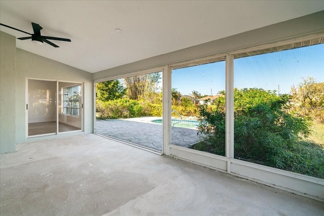 unfurnished sunroom with ceiling fan and lofted ceiling