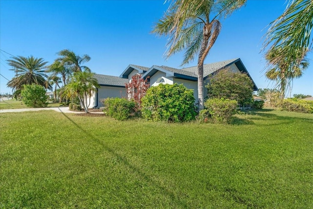 view of side of home with a lawn