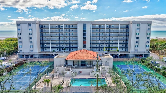 view of property featuring a water view and a community pool