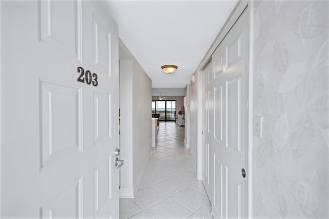 hall featuring light tile patterned floors