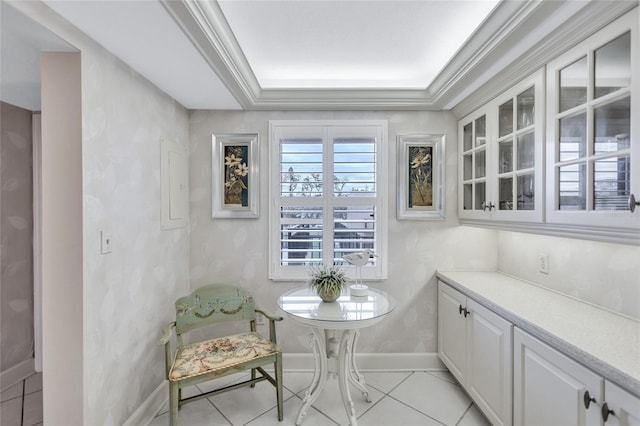 living area featuring a raised ceiling, light tile patterned floors, ornamental molding, and electric panel