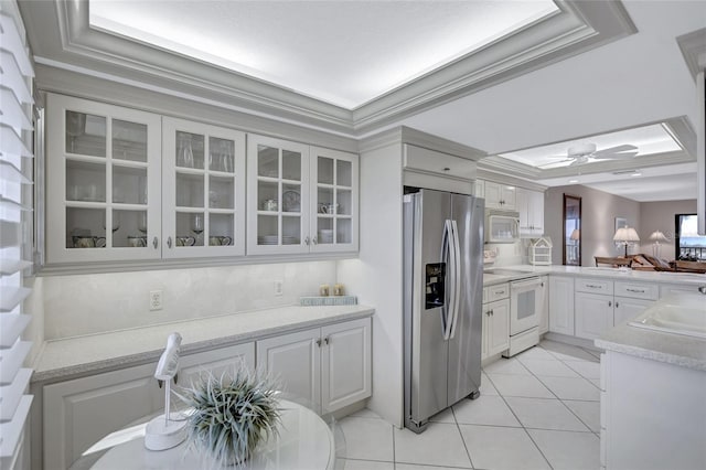 kitchen featuring white cabinetry, ceiling fan, white appliances, light tile patterned floors, and ornamental molding