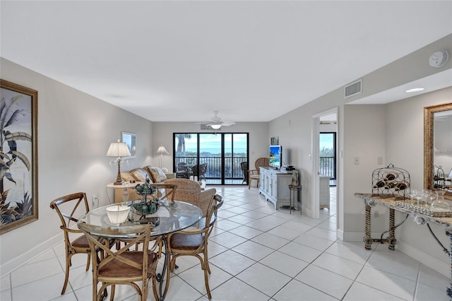 dining area featuring ceiling fan and light tile patterned floors