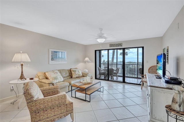 living room with ceiling fan and light tile patterned flooring