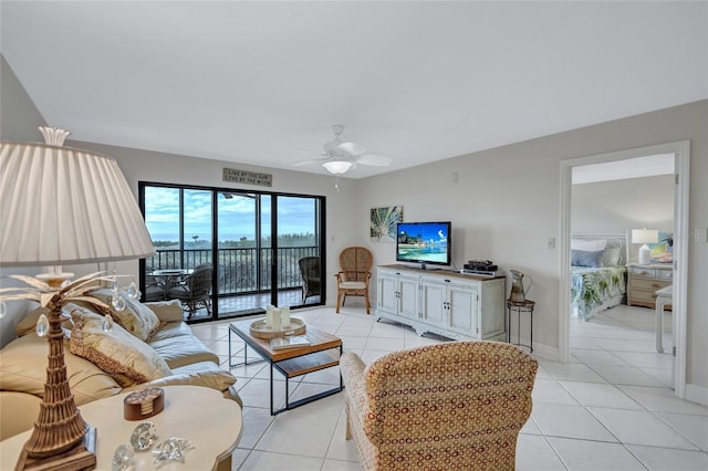 living room with ceiling fan and light tile patterned flooring