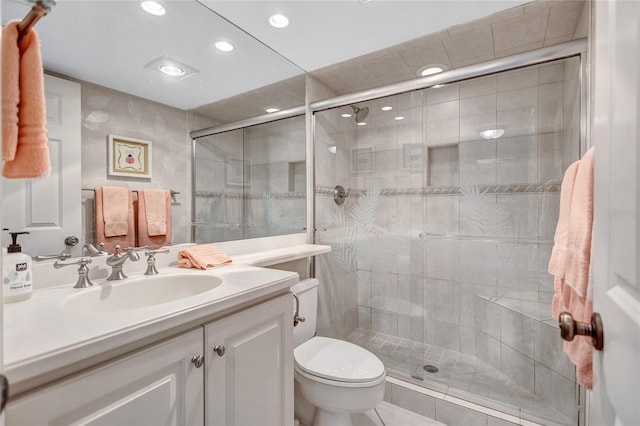 bathroom featuring tile patterned flooring, vanity, toilet, and an enclosed shower