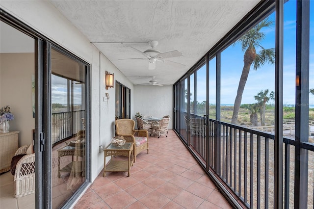 sunroom featuring a wealth of natural light and ceiling fan