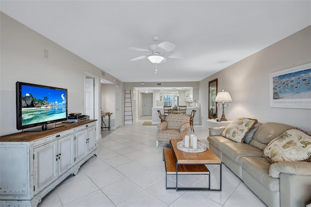 living room with ceiling fan and light tile patterned floors