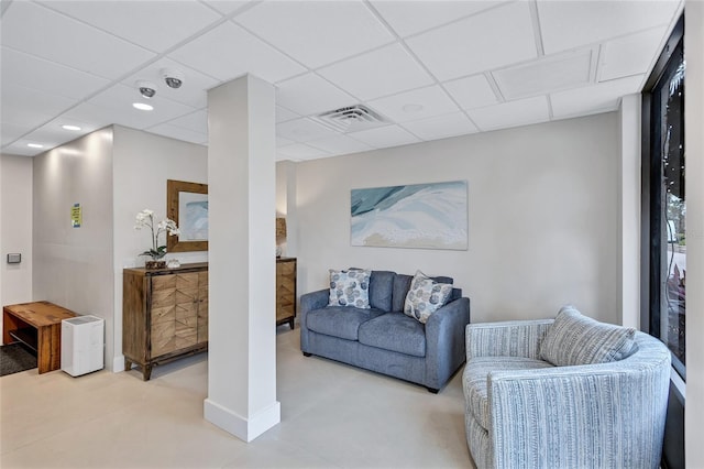 living room featuring a drop ceiling