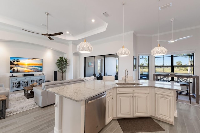 kitchen featuring dishwasher, ceiling fan, sink, and an island with sink