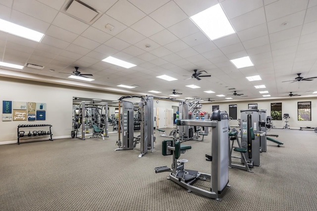 exercise room with a paneled ceiling and ceiling fan